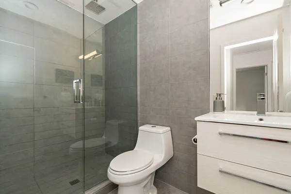 a bathroom with a sink toilet and shower