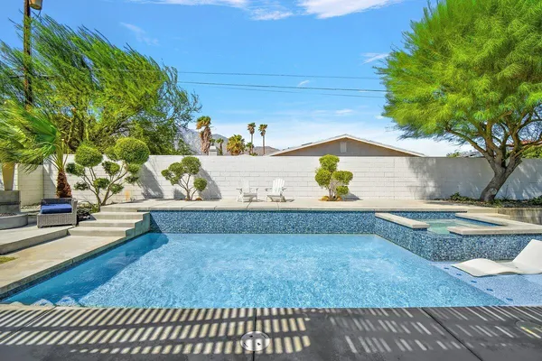 a view of swimming pool with outdoor seating