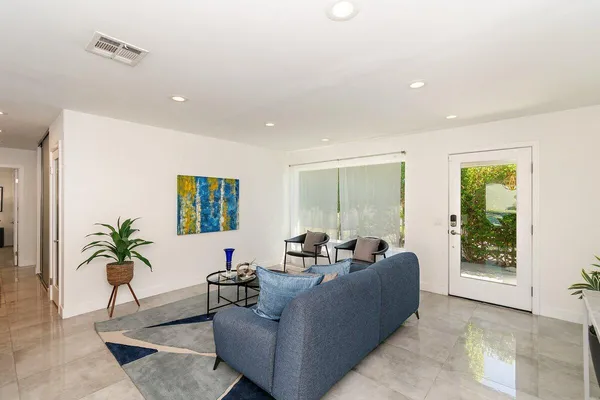 a living room with furniture and a potted plant