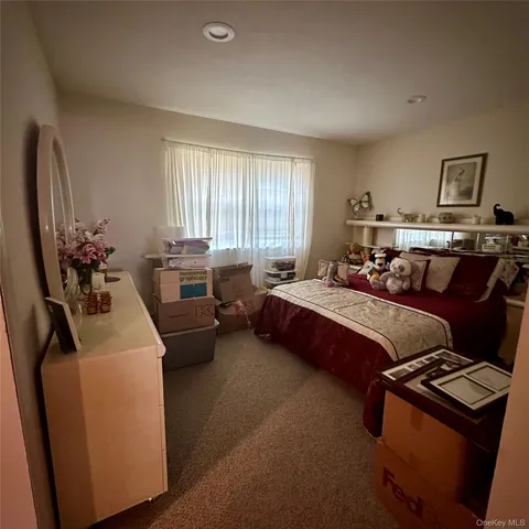 a bedroom with bed couch and window