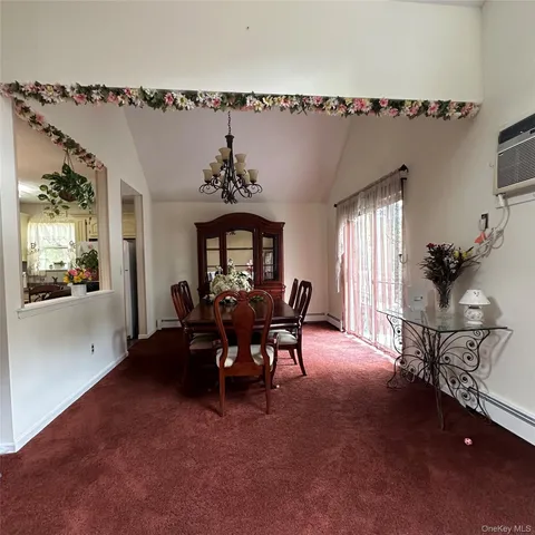 a view of a dining room with furniture and window