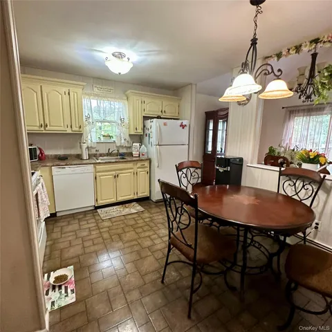a dining hall with a dining table and chairs with a dining table