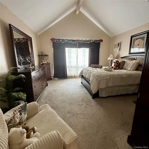 a spacious bedroom with a bed and glass window