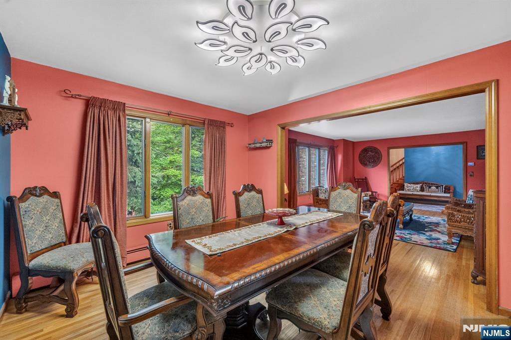 5110 Berkshire Valley Road Oak Ridge, NJ 07438 - Photo 9 of 49 a view of a dining room with furniture a chandelier and wooden floor