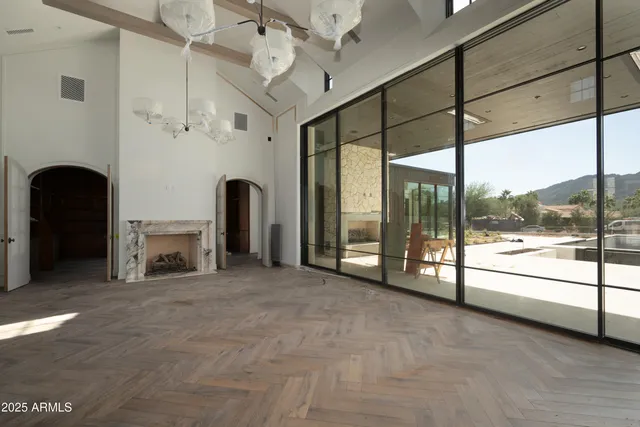 a view of an empty room with a fireplace and a large window