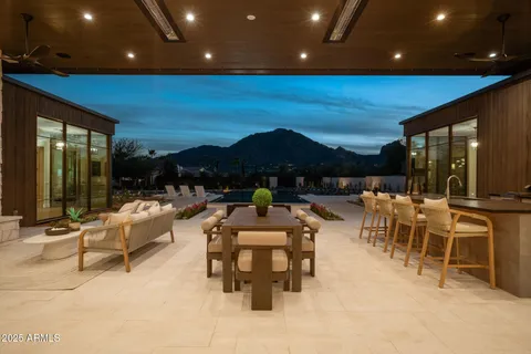 a front view of house with yard outdoor seating and covered with palm trees