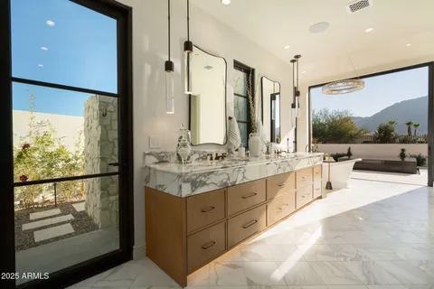 a bathroom with a granite countertop sink mirror vanity and toilet