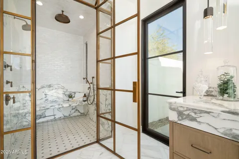 a large bedroom with a large bed and wooden floor