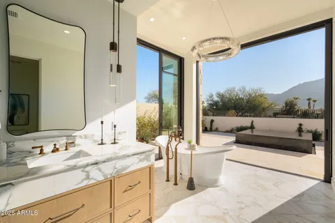 a living room with fireplace furniture and a potted plant