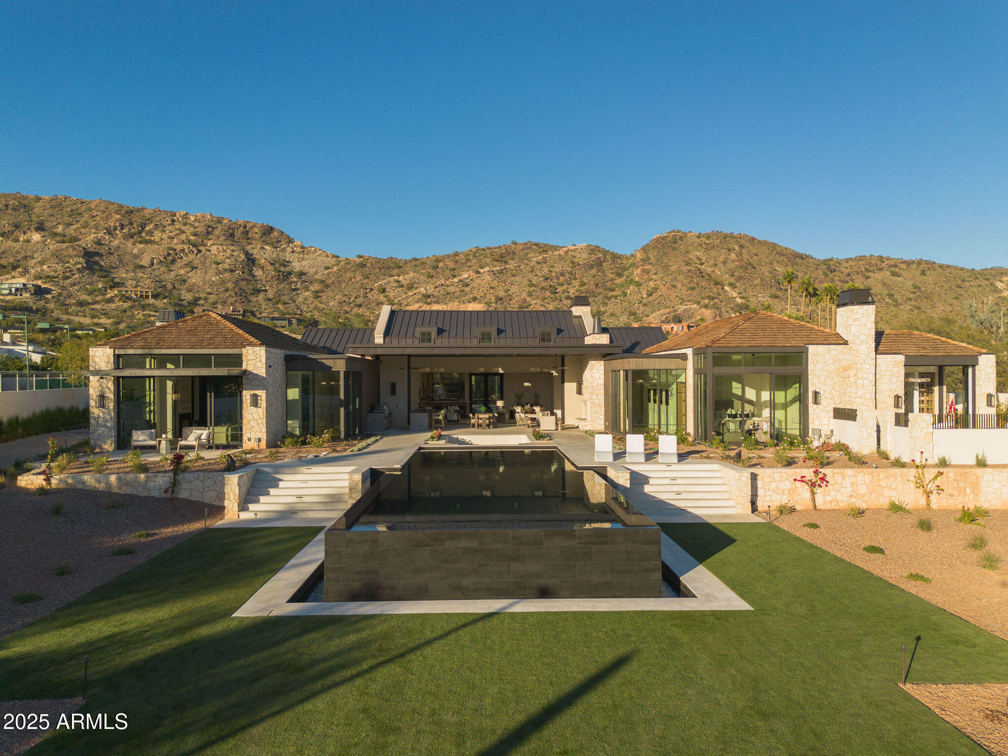 5902 East Cactus Wren Road Paradise Valley, AZ 85253 - Photo 4 of 72 a front view of a house with a yard table and chairs