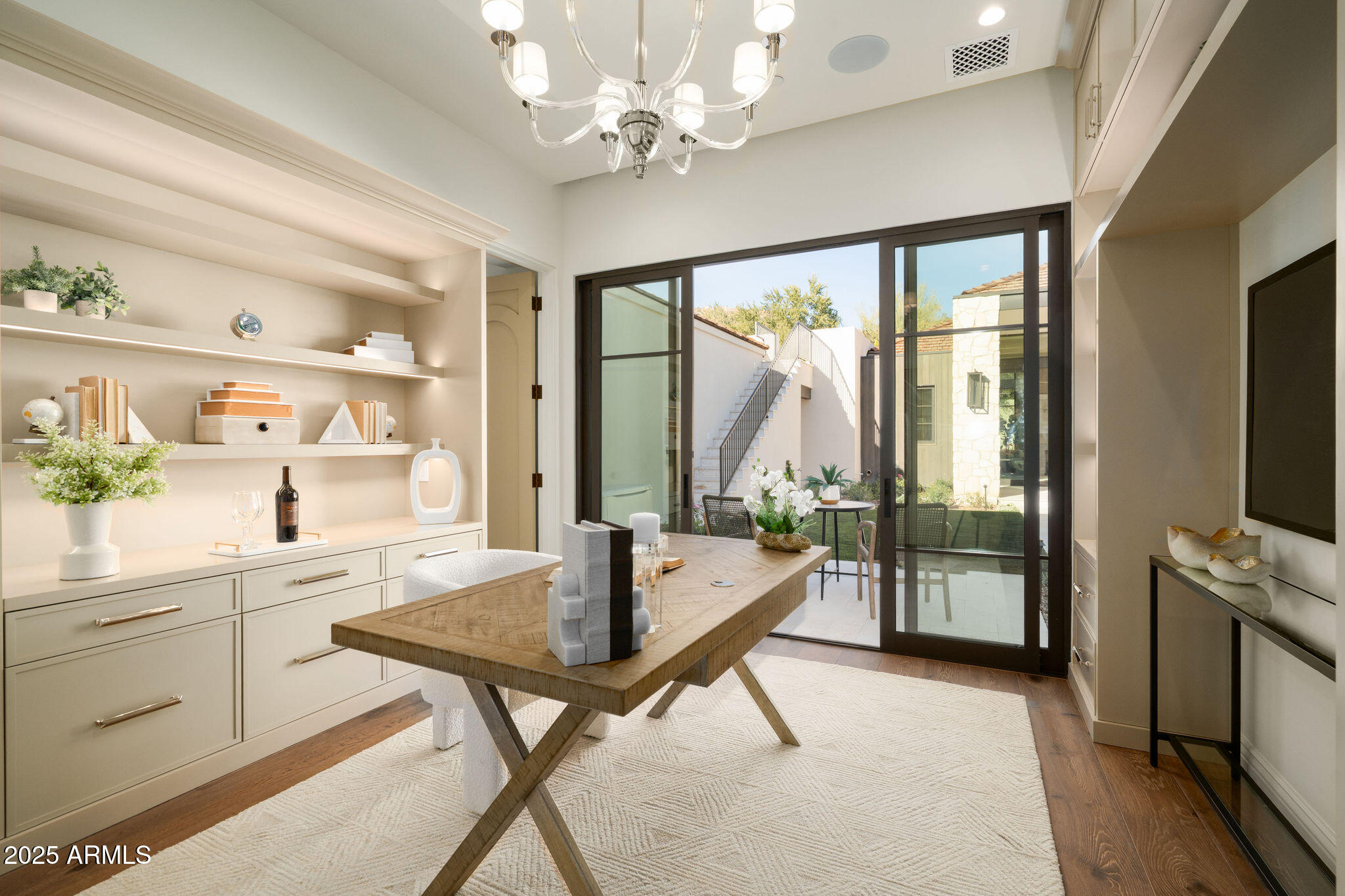 5902 East Cactus Wren Road Paradise Valley, AZ 85253 - Photo 44 of 72 a living room with dining table furniture a fireplace and a flat screen tv