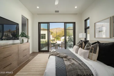 a dining room with furniture and a large window