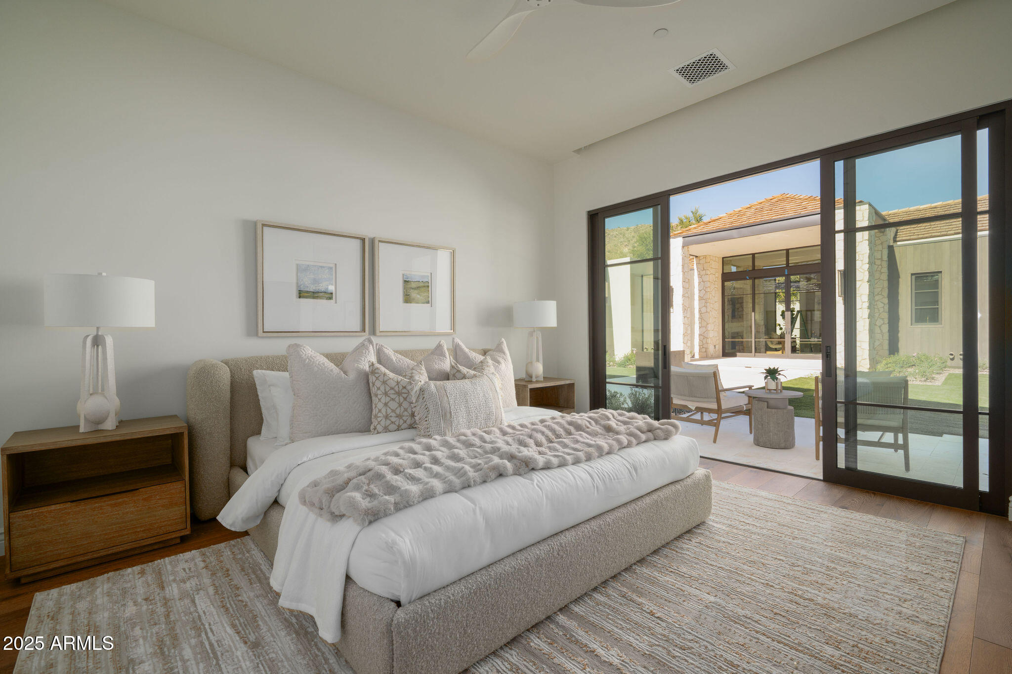 5902 East Cactus Wren Road Paradise Valley, AZ 85253 - Photo 49 of 72 a large bedroom with a large bed and wooden floor