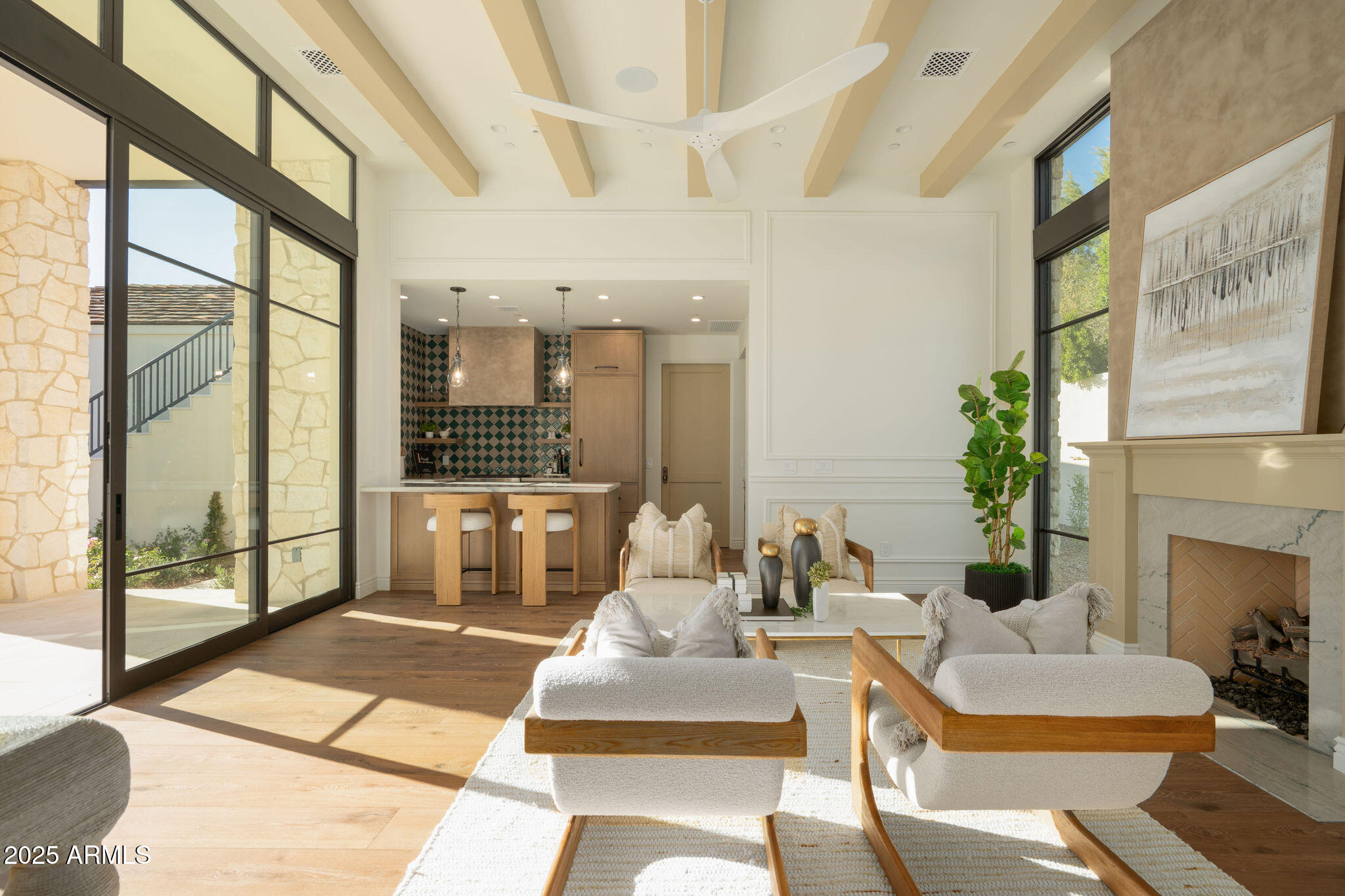 5902 East Cactus Wren Road Paradise Valley, AZ 85253 - Photo 56 of 72 a living room with furniture a fireplace and a floor to ceiling window