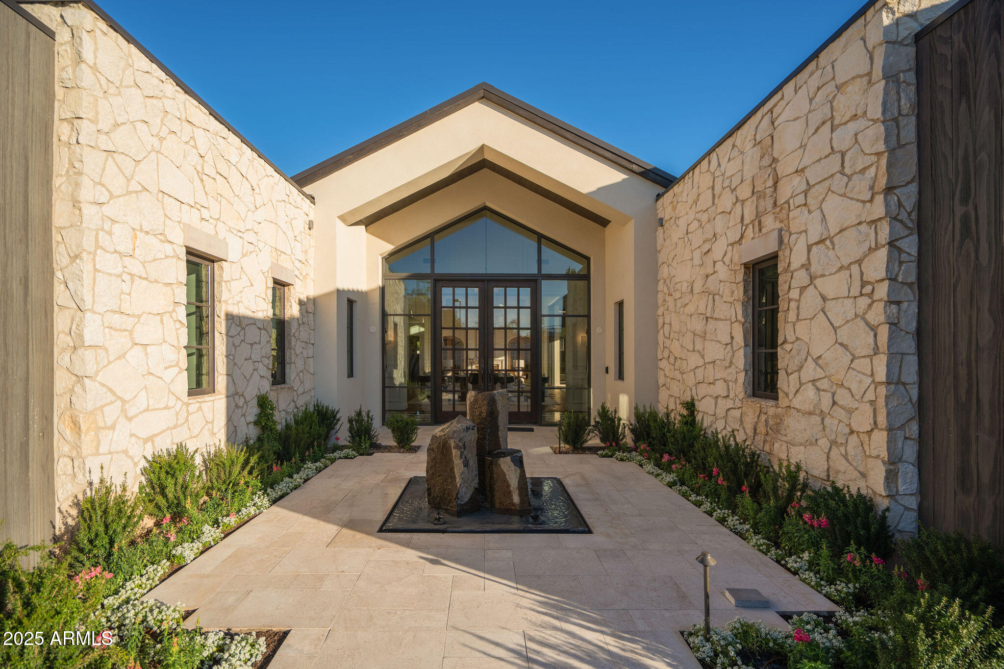 5902 East Cactus Wren Road Paradise Valley, AZ 85253 - Photo 6 of 72 a view of a brick house with potted plants next to a road