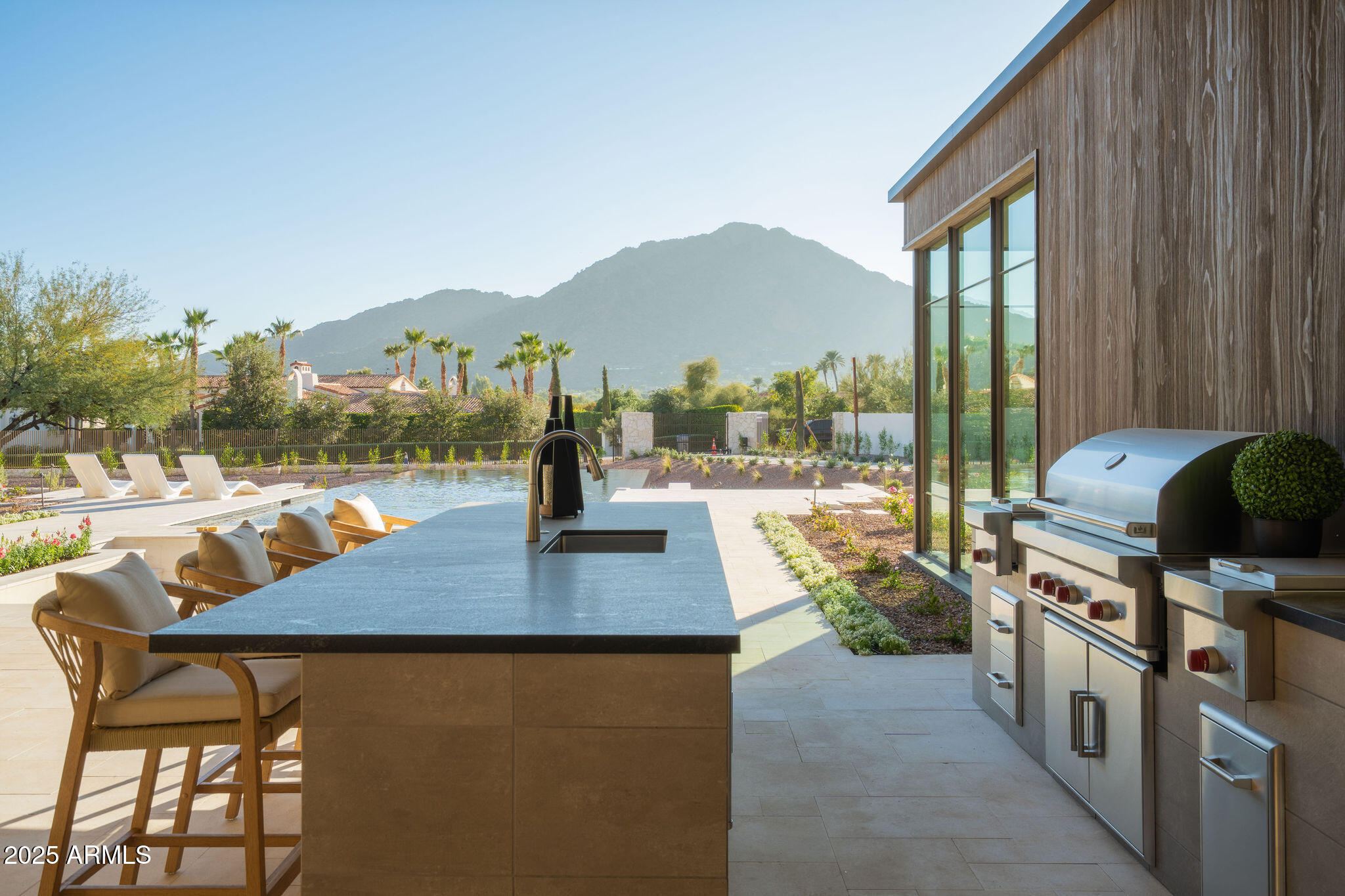 5902 East Cactus Wren Road Paradise Valley, AZ 85253 - Photo 67 of 72 a view of a swimming pool with a patio and a garden