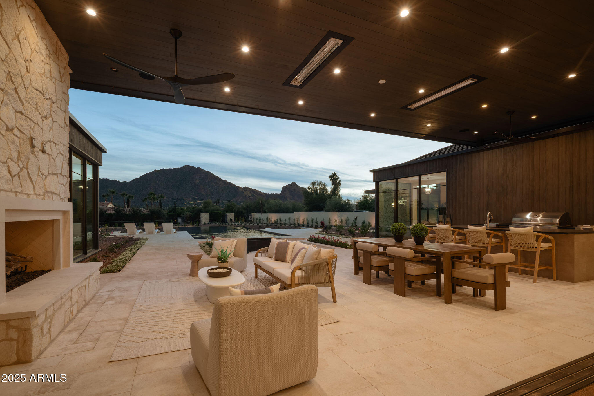 5902 East Cactus Wren Road Paradise Valley, AZ 85253 - Photo 71 of 72 a living room with furniture a fireplace and a projector screen