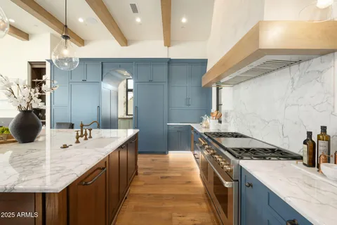 a living room with fireplace furniture and a large window