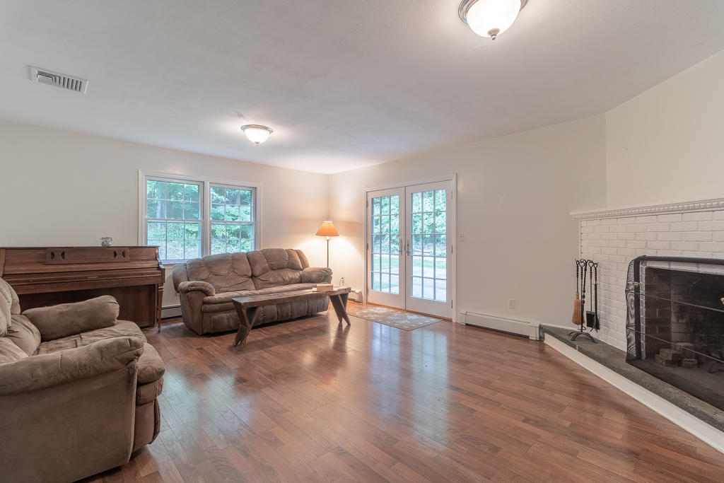 3 Hollow Spring Road Norwalk, CT 06854 - Photo 22 of 30 a living room with furniture and a fireplace