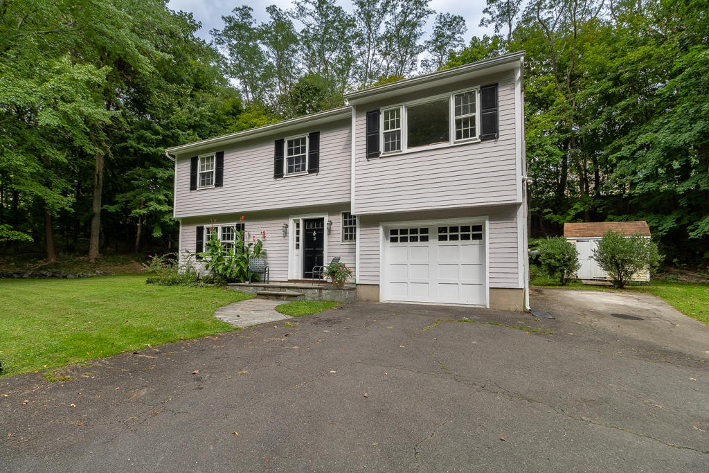 3 Hollow Spring Road Norwalk, CT 06854 - Photo 28 of 30 a front view of a house with a yard and garage