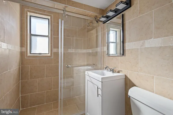 a bathroom with a sink toilet and shower