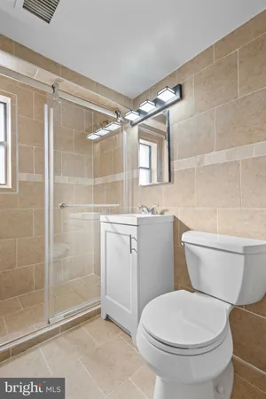 a bathroom with a toilet and a shower