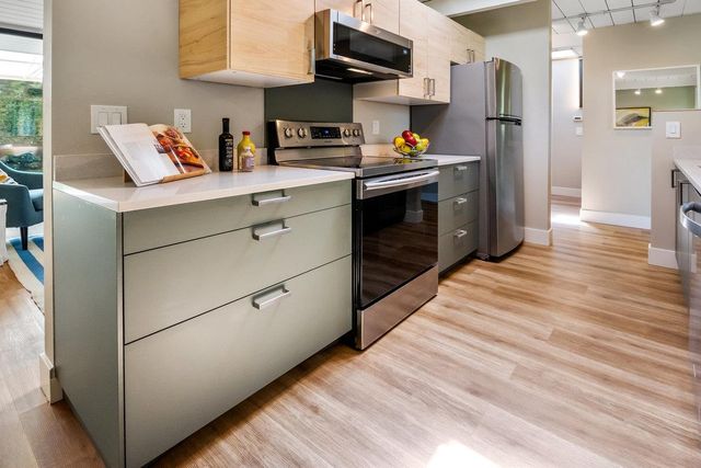 a kitchen with stainless steel appliances a refrigerator sink and cabinets