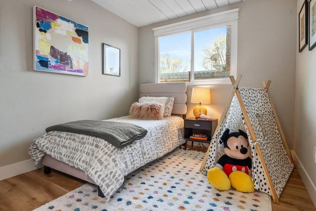 a bedroom with bed and wall painting