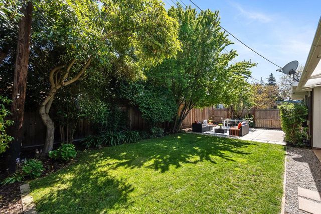 a view of a backyard with sitting area