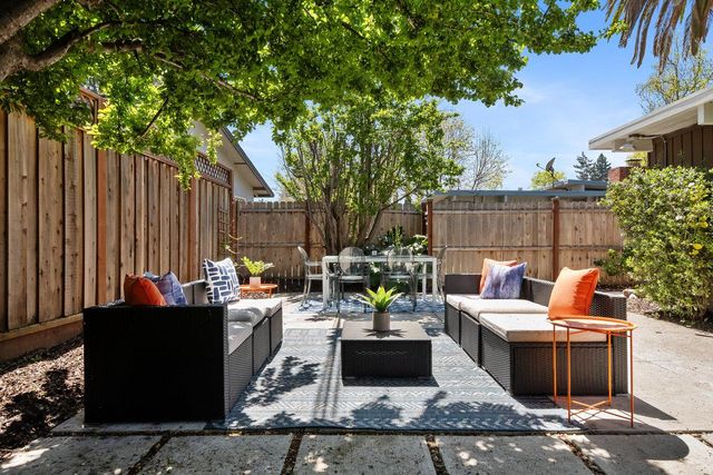 a view of a patio with couches chairs and a potted plant