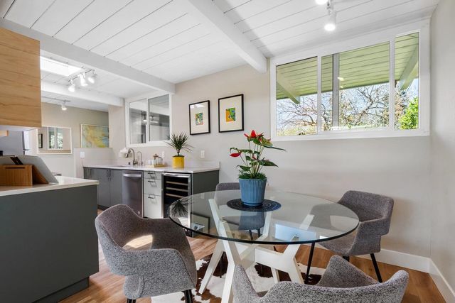 a view of a dining room with furniture and a potted plant