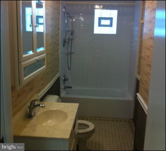 8125 Ridgely Oak Road Parkville, MD 21234 - Photo 3 of 13 a bathroom with a sink and a mirror