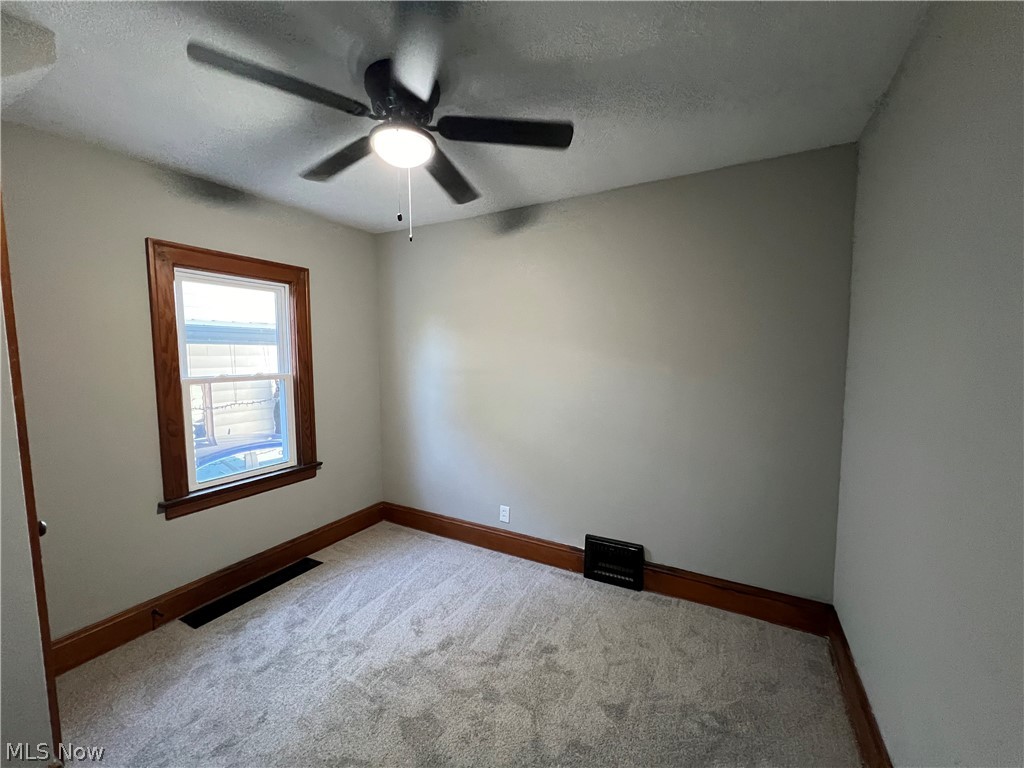 4523 Maplecrest Avenue Parma, OH 44134 - Photo 28 of 31 Spare room featuring ceiling fan, a textured ceiling, and carpet flooring