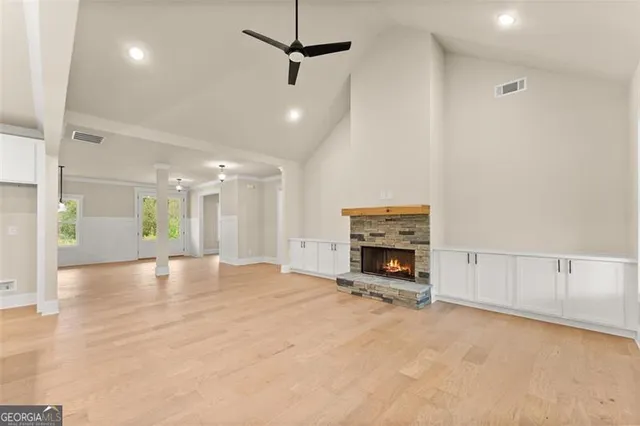 a view of an empty room with fire place and a fireplace