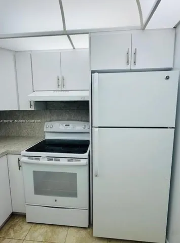 a bathroom with a granite countertop sink a toilet and bathtub