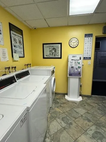 a view of a room with a sink and chandelier fan