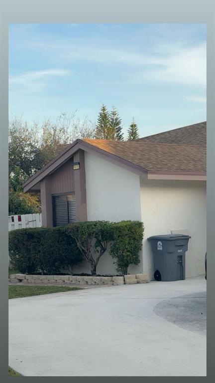 9616 Golf State Park Way Boca Raton, FL 33428 - Photo 4 of 22 a front view of a house with a yard and garage