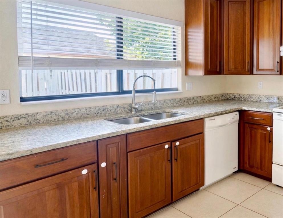 9616 Golf State Park Way Boca Raton, FL 33428 - Photo 8 of 22 a kitchen with granite countertop cabinets sink and window