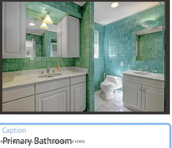 a bathroom with a sink toilet and mirror