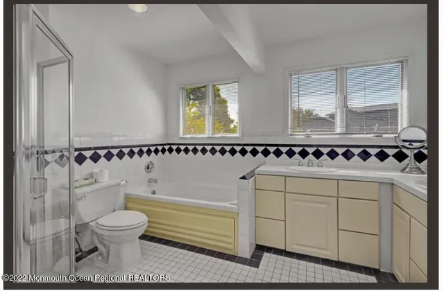 a bathroom with a shower a toilet and a sink