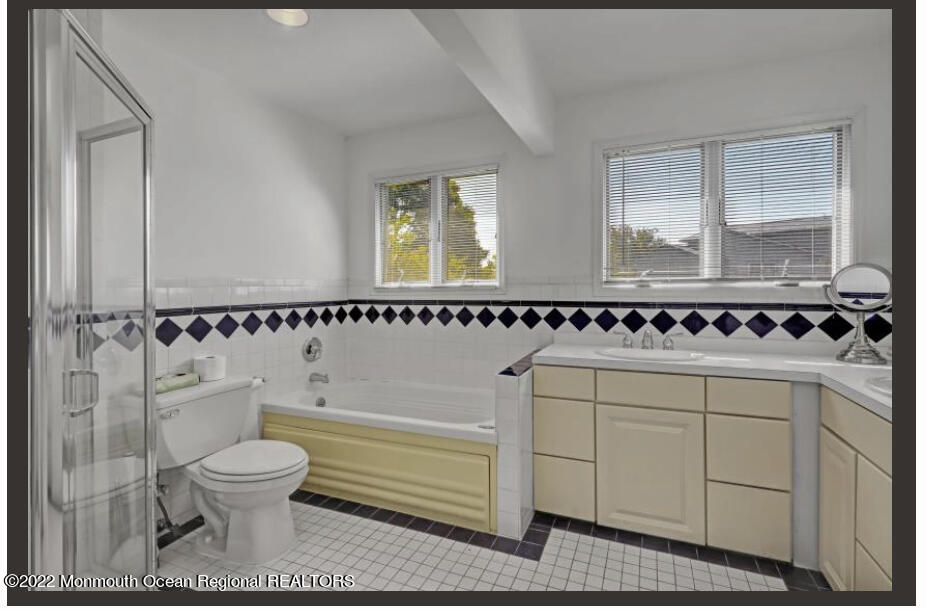 112 Roseld Avenue Deal, NJ 07723 - Photo 26 of 39 a bathroom with a toilet sink and mirror