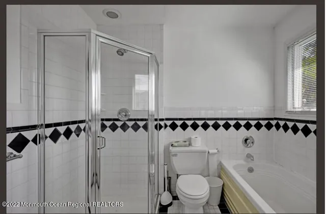 a bed sitting in a spacious bedroom next to a window