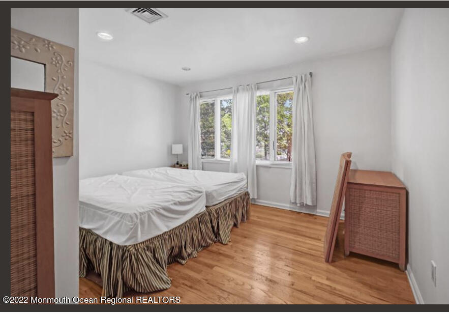 112 Roseld Avenue Deal, NJ 07723 - Photo 29 of 39 a bedroom with a bed and a wooden floor