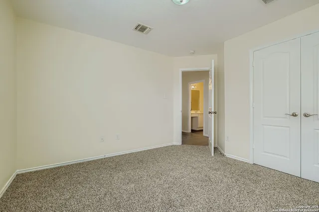 a view of an empty room and closet area