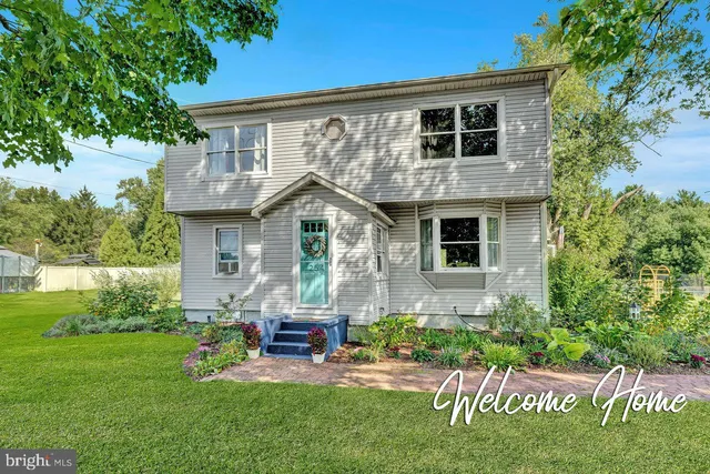 a front view of house with a garden and patio