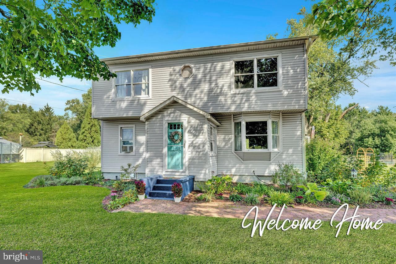 a front view of house with a garden and patio
