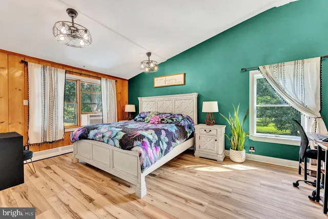 a bedroom with a large bed and a window