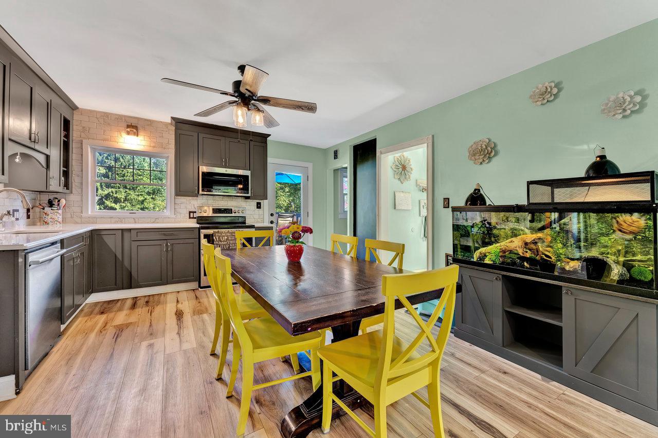 254 Friendship Road Cranbury, NJ 08512 - Photo 16 of 44 a kitchen with stainless steel appliances kitchen island granite countertop a stove a sink and a refrigerator