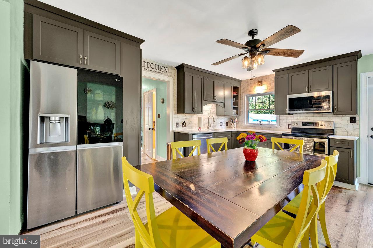 254 Friendship Road Cranbury, NJ 08512 - Photo 17 of 44 a kitchen with a dining table chairs and refrigerator