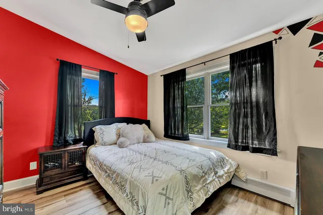 a bedroom with furniture and a flat screen tv